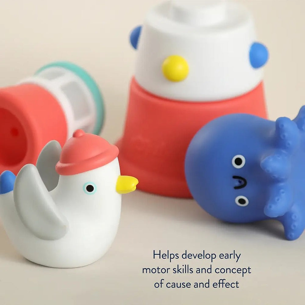Itzy Ritzy Stack & Squirt bath toy set with a white chick, blue whale, and red-white stackable cups.