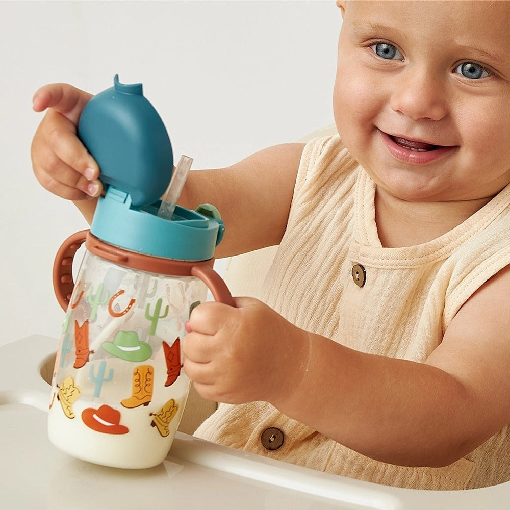 Itzy Ritzy Straw Cup with Snap-Close Lid Cup in turquoise lid, clear bottle with cactus print.