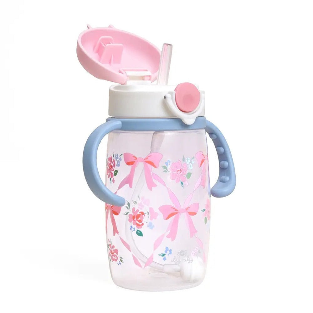 Itzy Ritzy Straw Cup with Snap-Close Lid in Clear Cup with Pink Floral Print and Blue Handles.