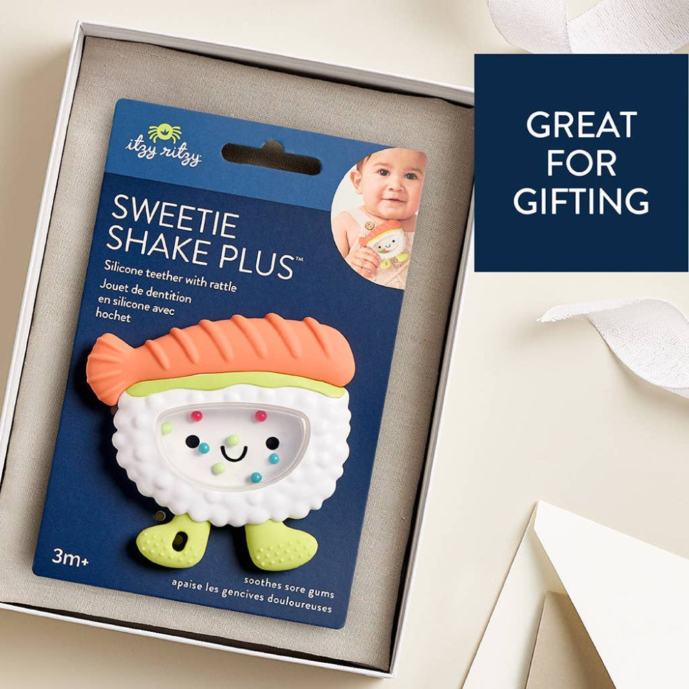 Itzy Ritzy Sweetie Shake Plus teether rattle with orange top and lime-green feet on blue packaging