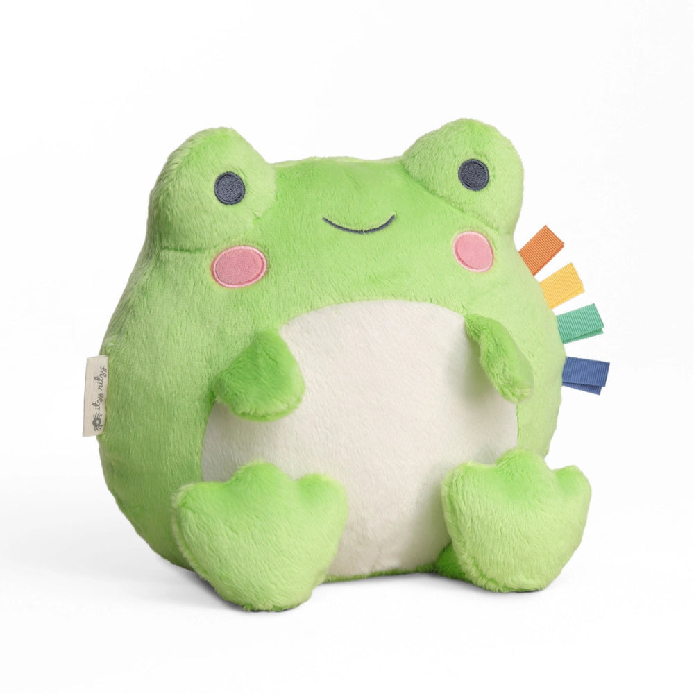 Itzy Ritzy Sweetie Snuggles Plush frog toy, bright green with white belly, pink cheeks, and multicolor ribbon tags
