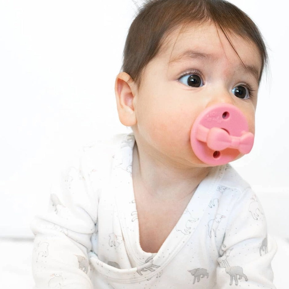 ITZY RITZY Itzy Ritzy Sweetie Soother Orthodontic Pacifier Sets (0-6M) pink orthodontic pacifier set with bow-shaped guard and matching bunn