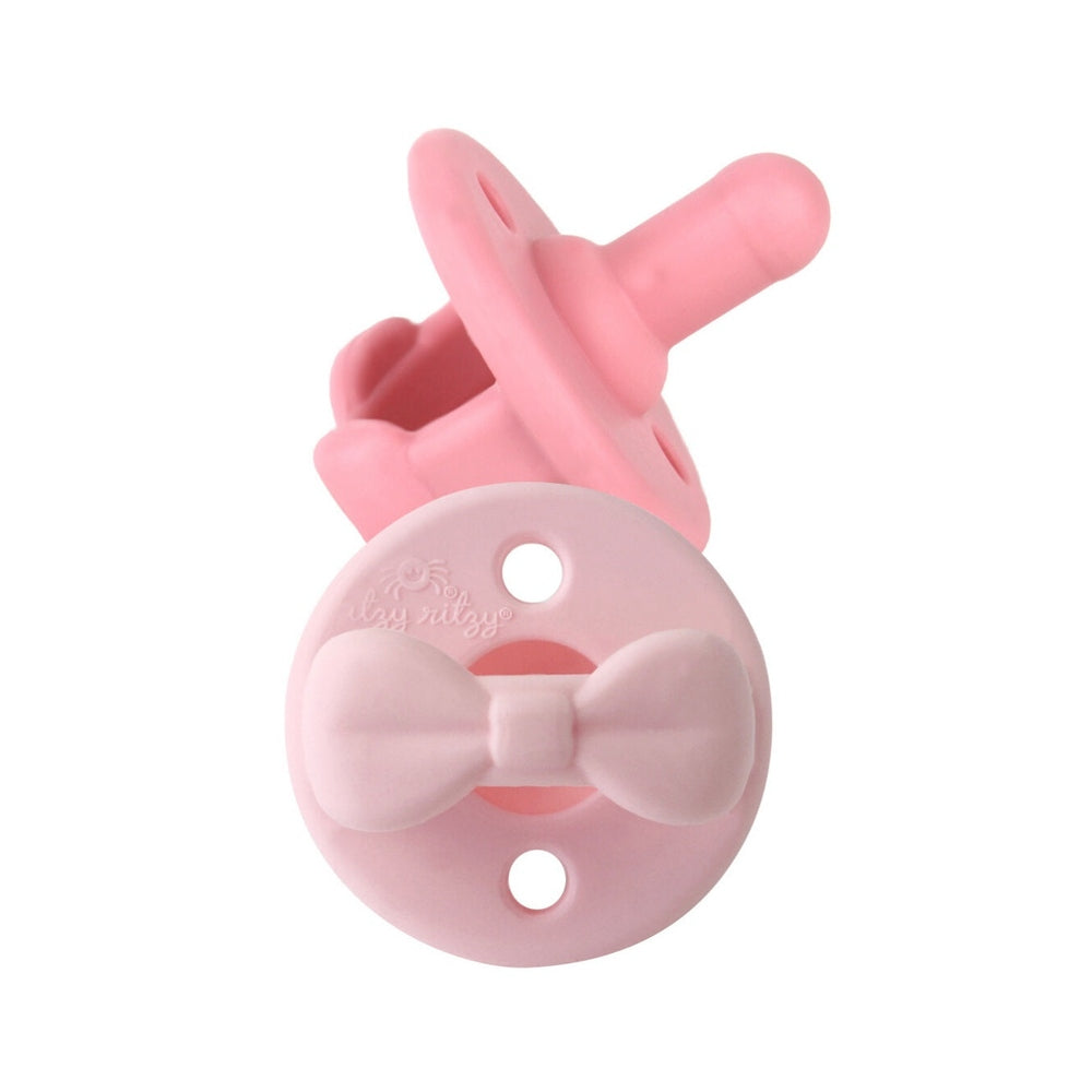 Itzy Ritzy Sweetie Soother Pacifier pink with bow, silicone nipple, 6-18M suitability.