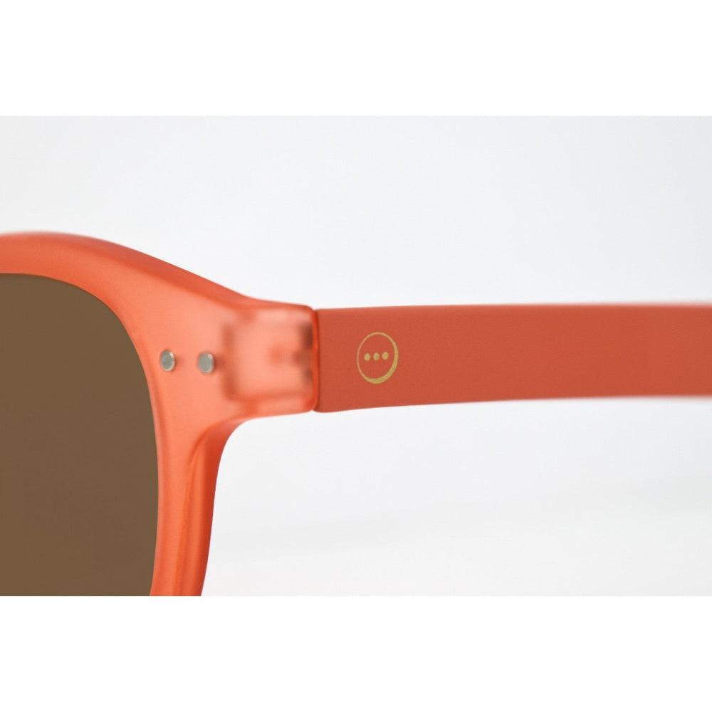 IZIPIZI Sun Junior sunglasses, warm orange frame with subtle logo on temple