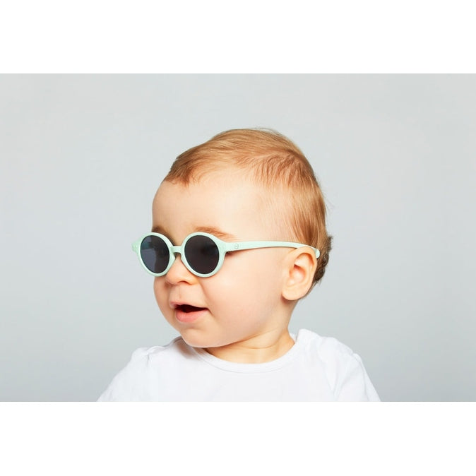 IZIPIZI Baby Sky Blue sunglasses with round frames worn by a toddler