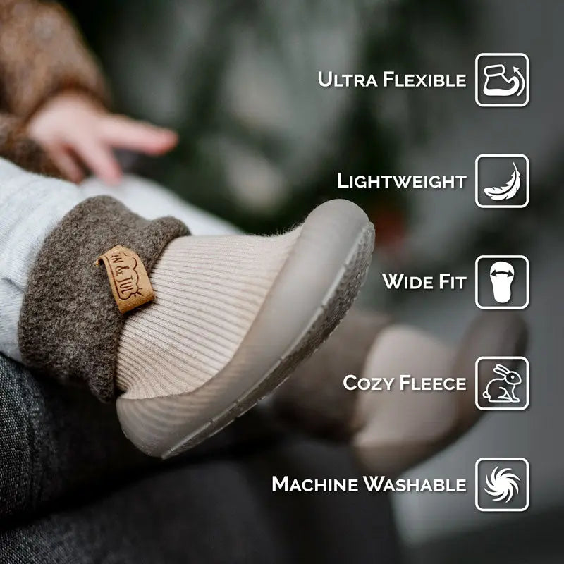 Jan & Jul Cozy Sock Shoes Red on a baby's foot, showing ultra flexible, cozy fleece, wide fit, machine washable.