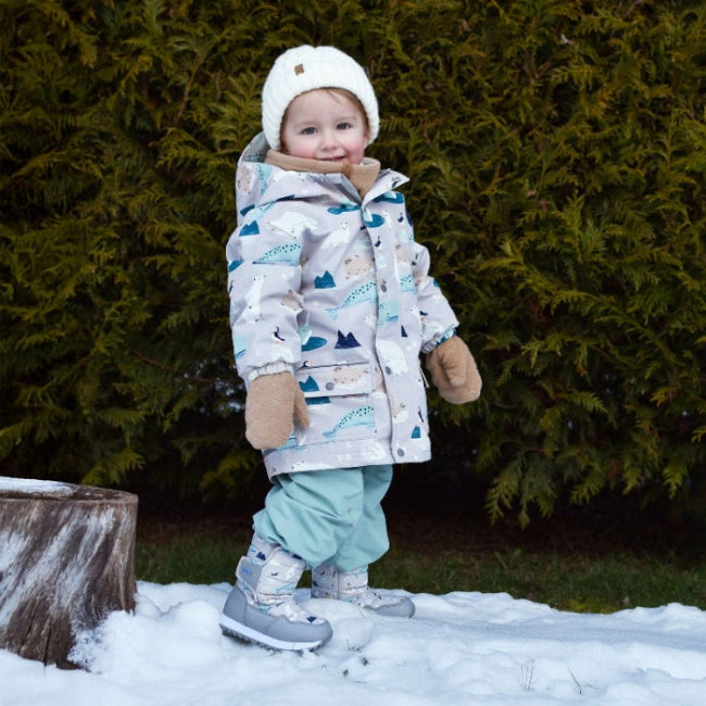 JAN & JUL fleece mittens Soft Brown worn by a toddler as she plays in the snow in a warm coat.