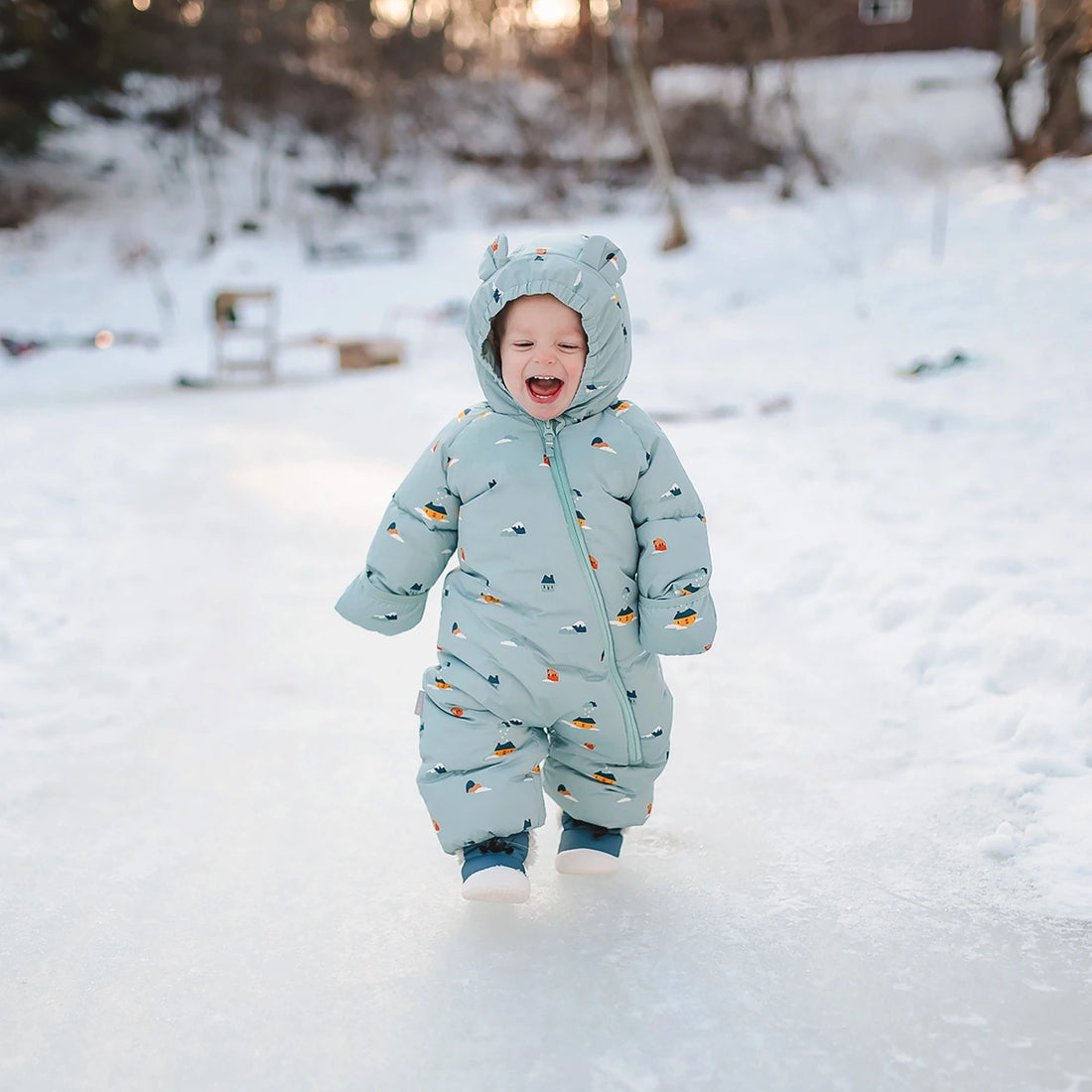 Jan & Jul Baby Insulated Snowsuit Home Sweet Home — child wearing the insulated snowsuit in snow