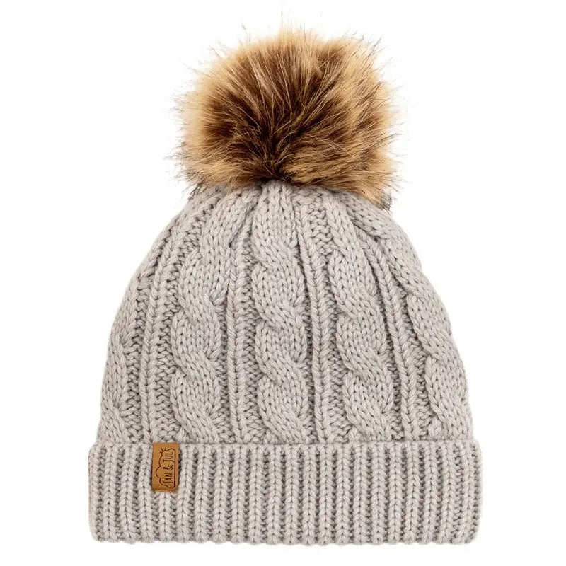 Jan & Jul Kids Cable Knit Twinning Beanies Grey with brown faux-fur pom displayed with folded cuff.