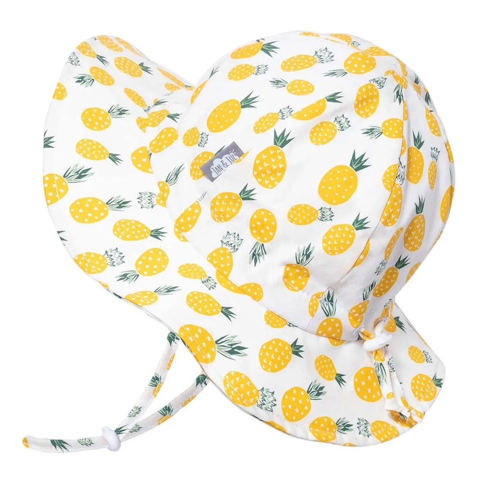 Jan & Jul Kids Cotton Floppy Hat, white with yellow pineapple print and adjustable ties.
