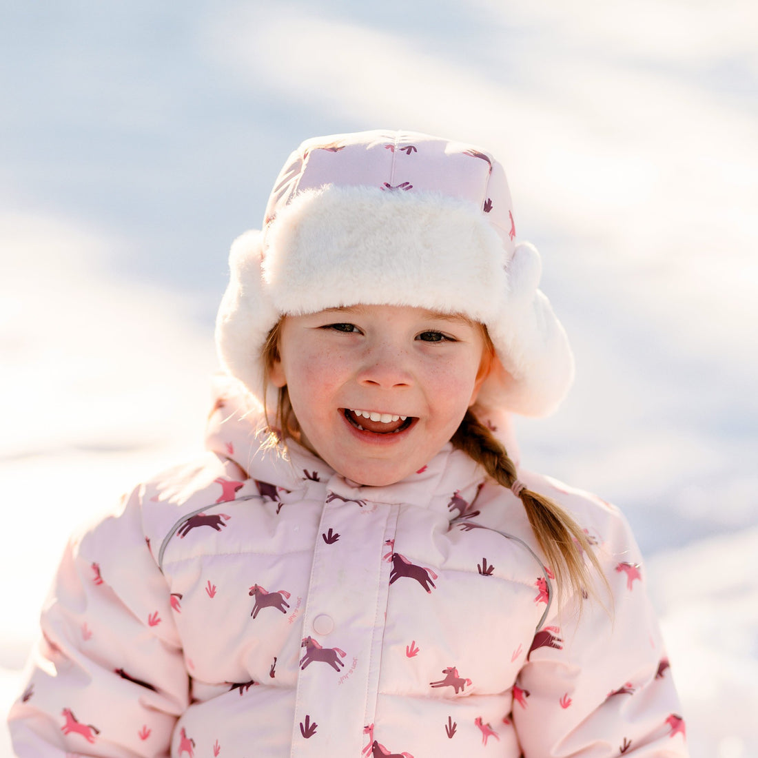 Child wearing the Pink Ponies insulated winter hat outdoors