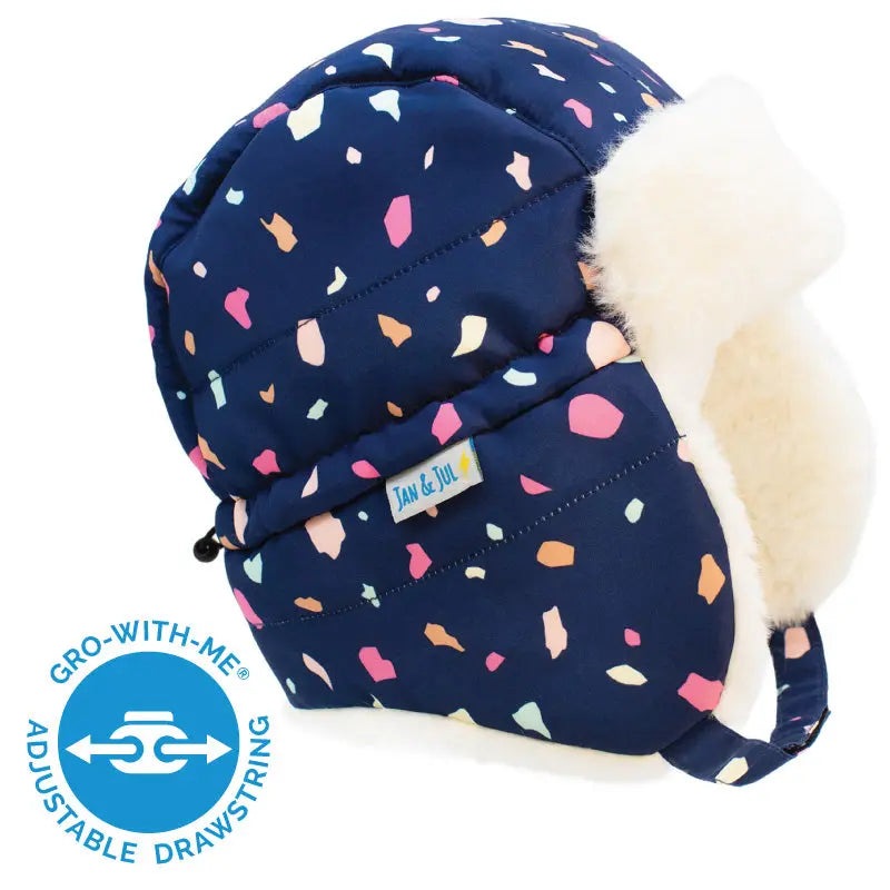 Jan & Jul Kids Insulated Winter Hat Terrazzo navy with colorful confetti pattern and cream faux-fur ear flaps