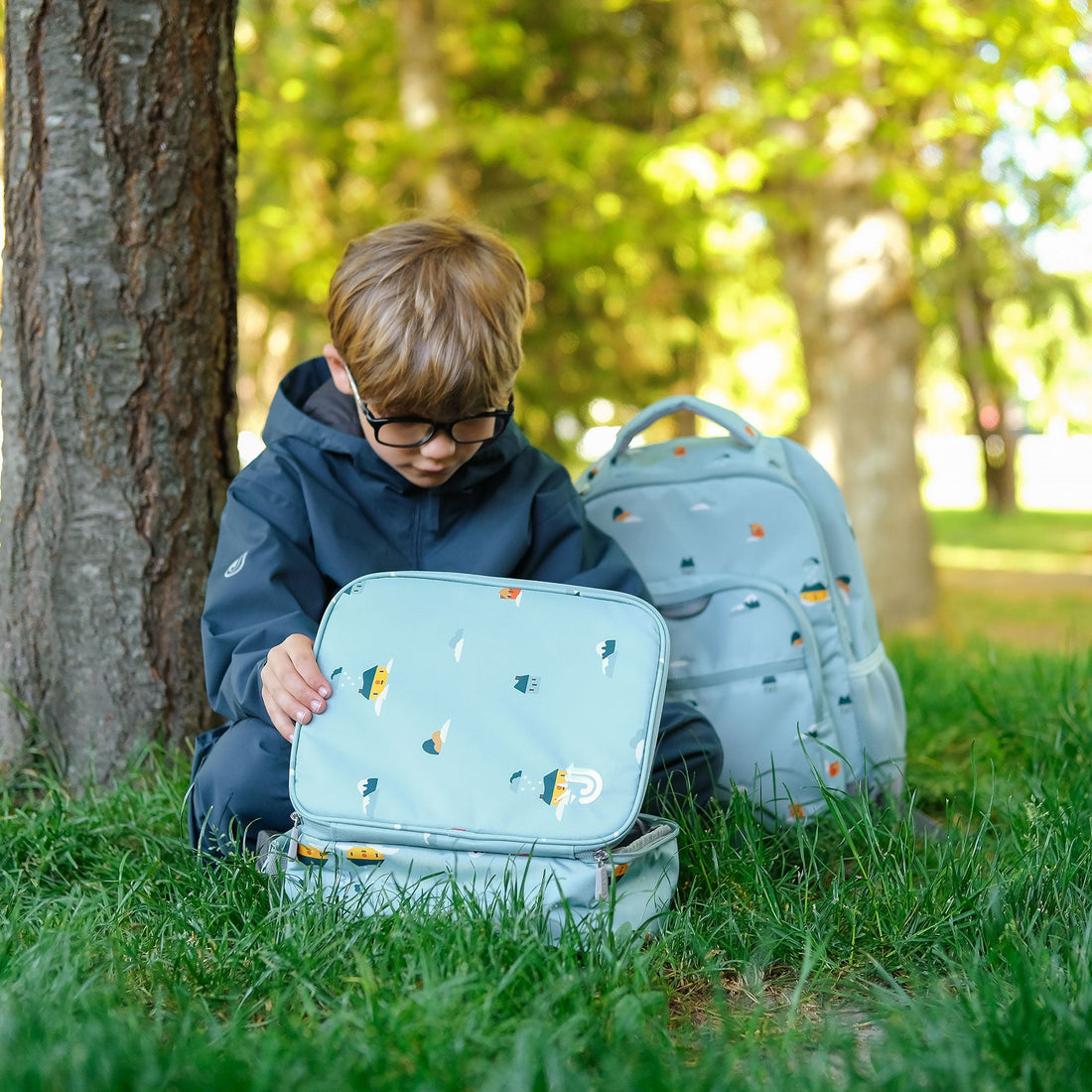 Child with the Home Sweet Home lunch bag and matching backpack