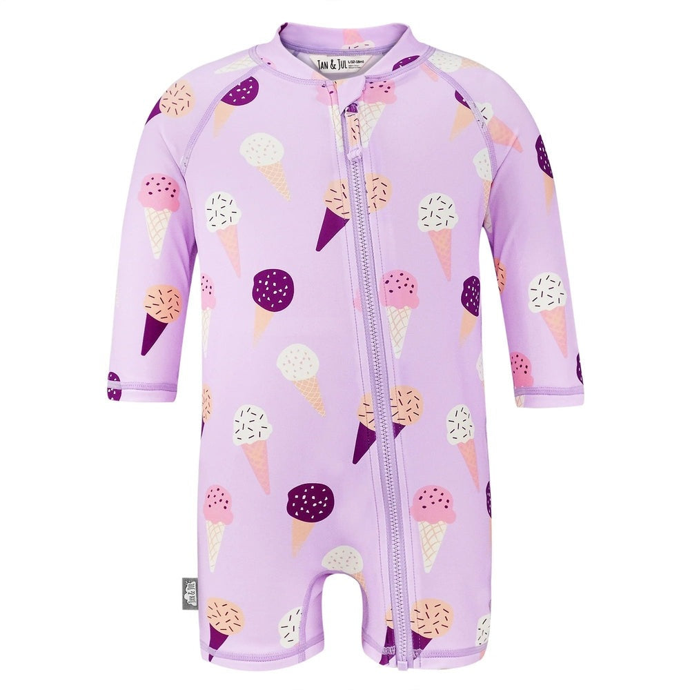 Jan & Jul Kids One Piece UV Sun Suit Lavender Ice Cream, lavender zip-front swimsuit worn by a toddler.