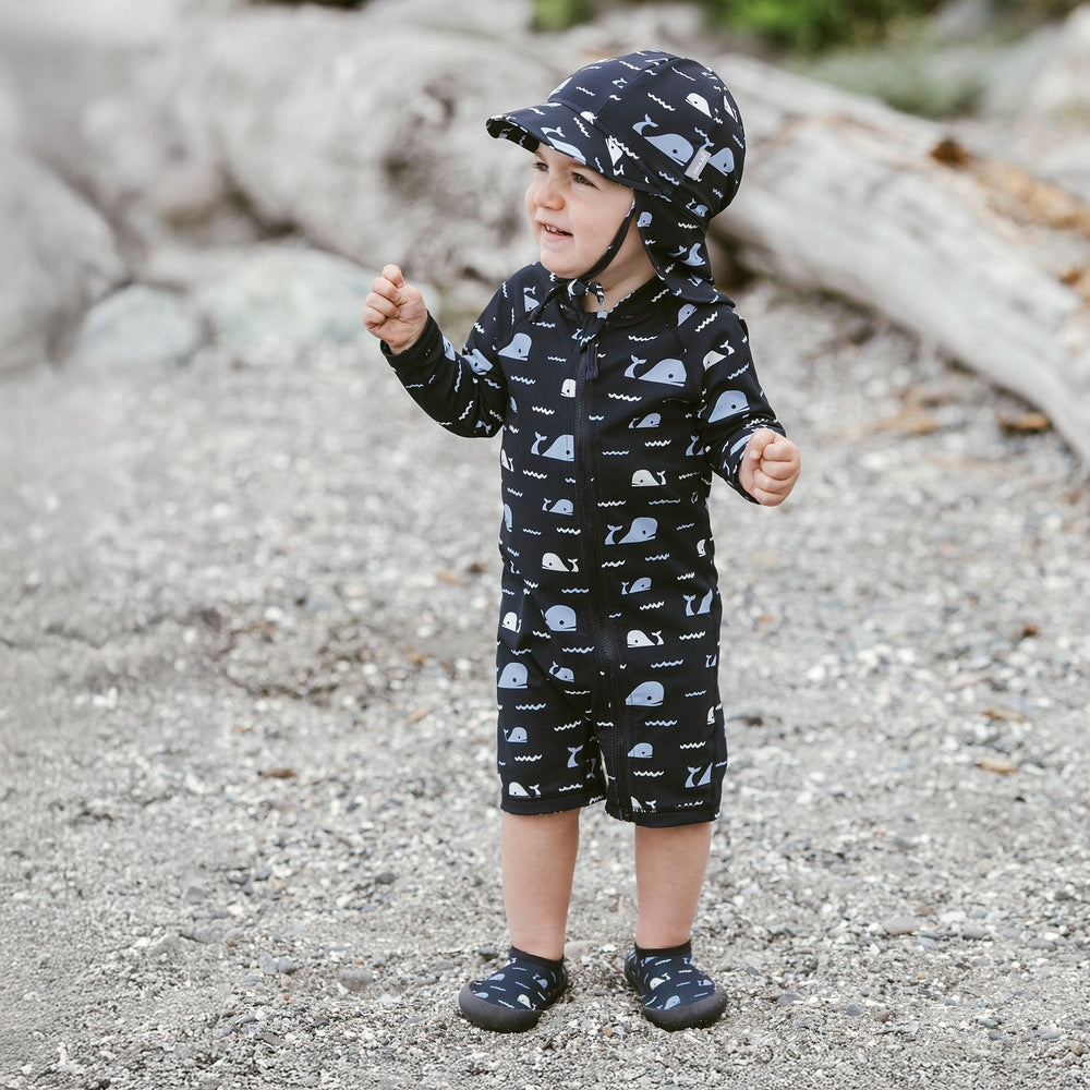 JAN & JUL Jan & Jul Kids One Piece UV Sun Suit Navy Whale Tales with matching bucket hat, long sleeves, shorts length, front zip img 3/8