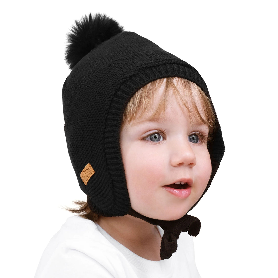 Child wearing the Jan & Jul Jet Black Pom-Pom Knit Hat, side view.