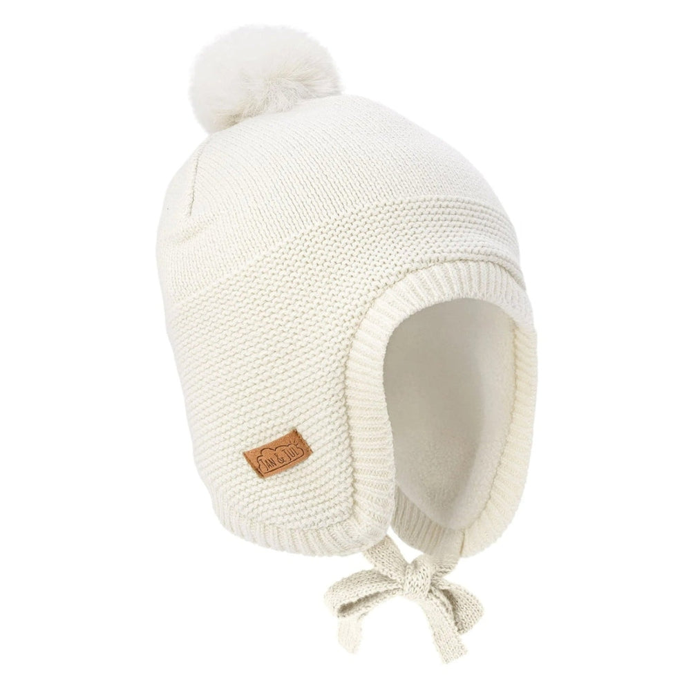 Jan & Jul Kids Pom-Pom Knit Hats Vanilla Cream; cozy cream knit beanie with fluffy pom-pom, ear-flap sides and tied strings.