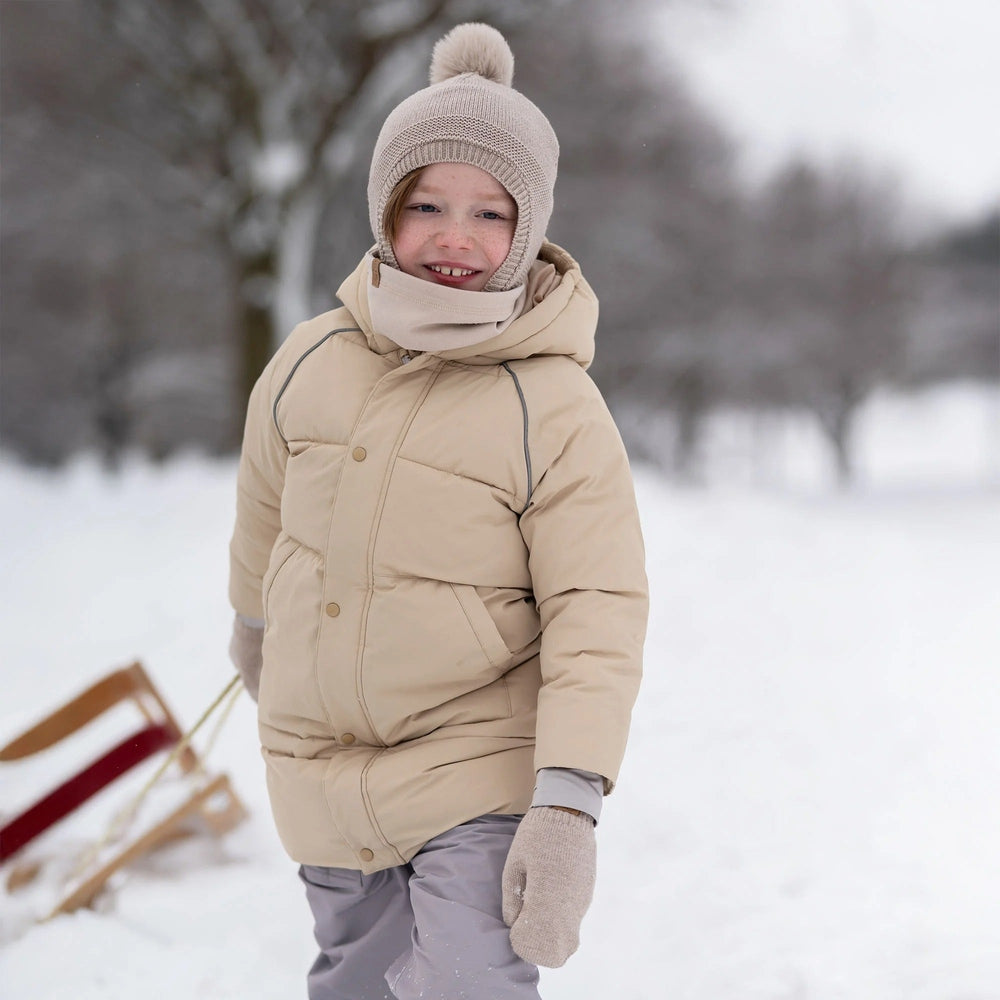 JAN & JUL Kids Pom-Pom Knit Hat in Wheat Field beige with fluffy pom-pom for winter warmth