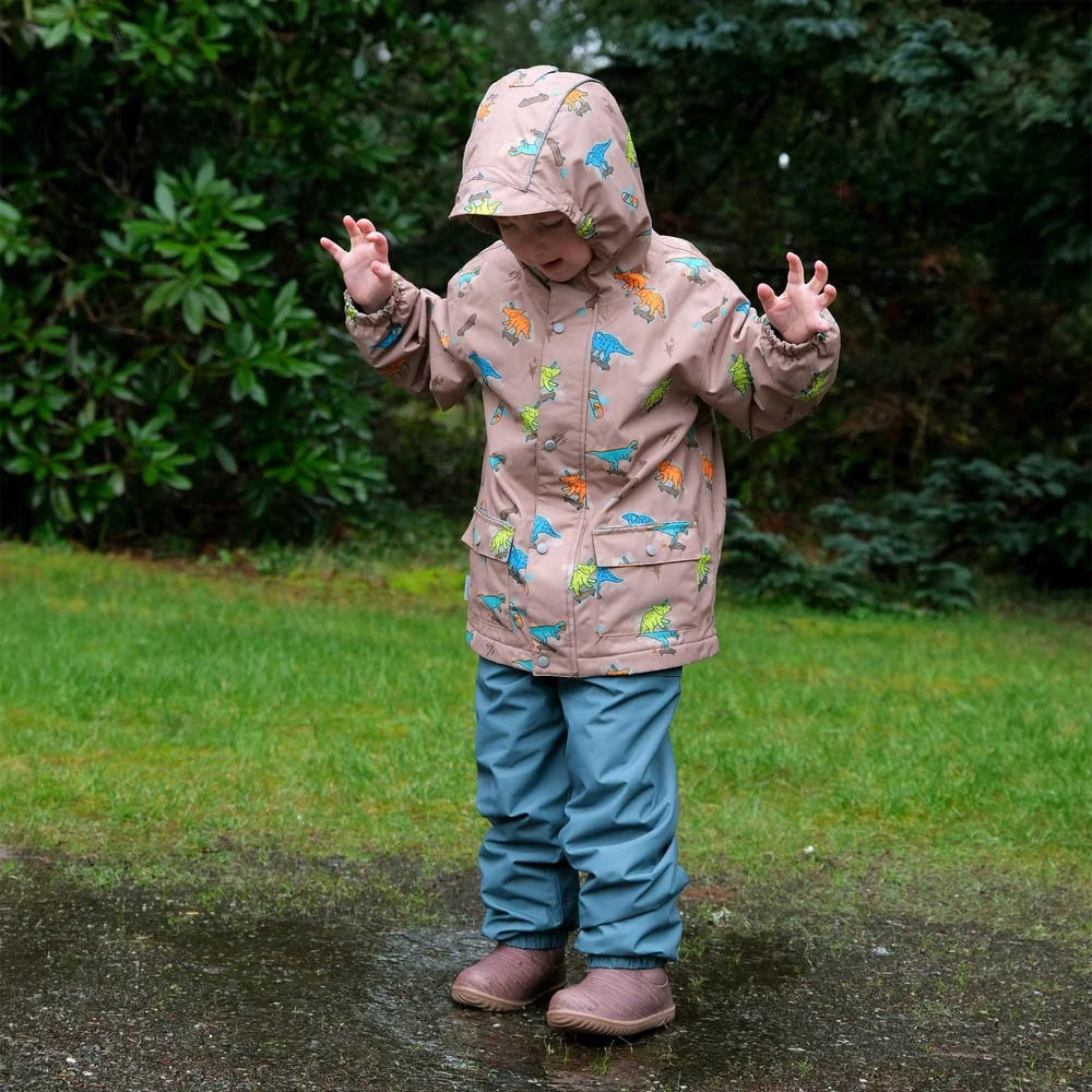 Child wearing Jan & Jul Dark Spruce single-layer rain pants outdoors