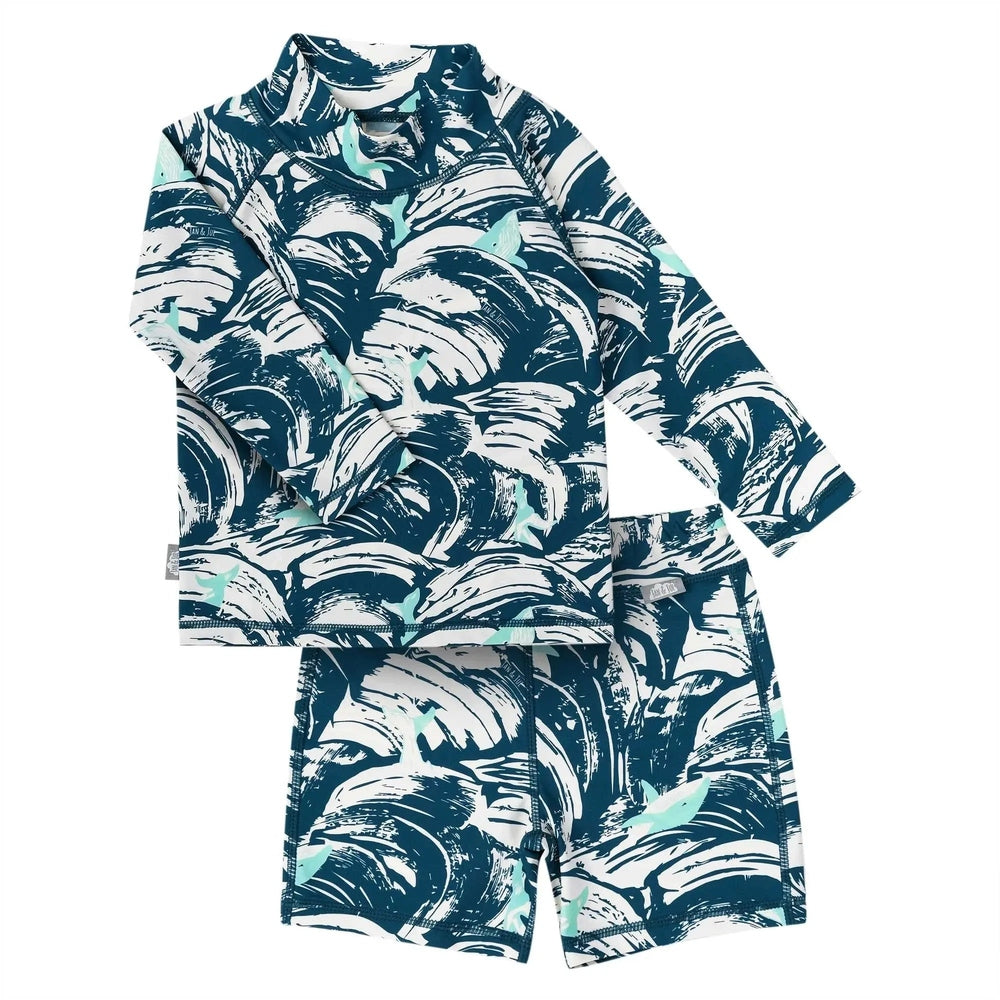 Jan & Jul Kids UV Rashguard Set Wave Rider two-piece, teal navy tropical print, laid flat with sleeves spread.