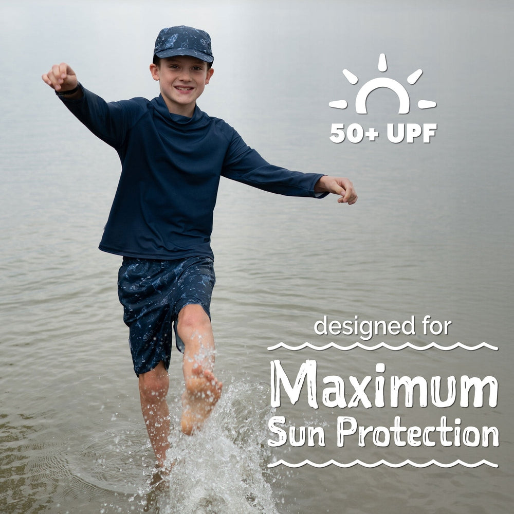 JAN & JUL Jan & Jul Kids UV Swim Shorts Navy Whale Play paired with matching long-sleeve rash guard and cap img 3/6