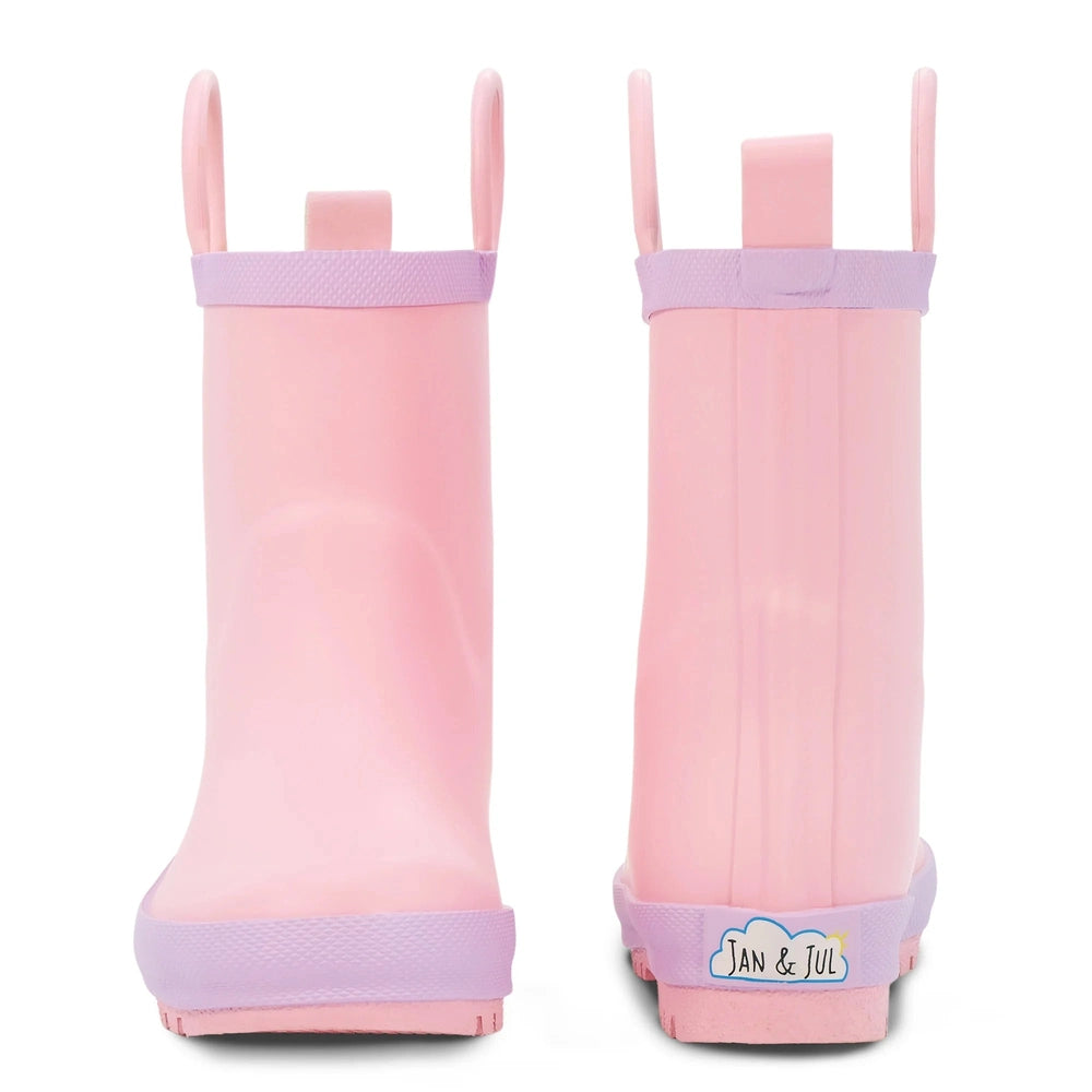 Jan & Jul Puddle Dry toddler rain boots in pink with lavender trim and sole, back view with logo.