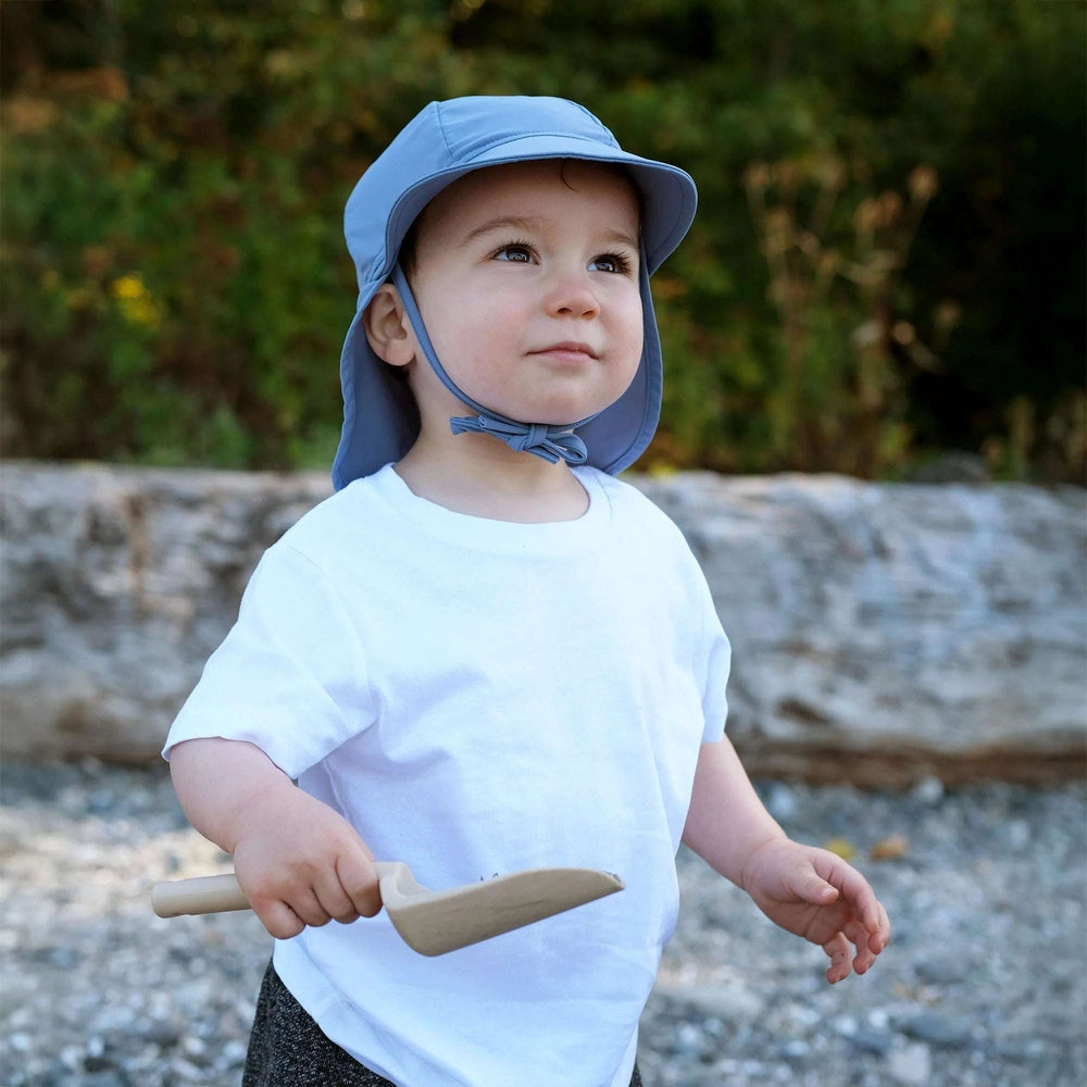 JAN & JUL Sun Soft UV baby cap blue-grey with chin strap worn by toddler outdoors