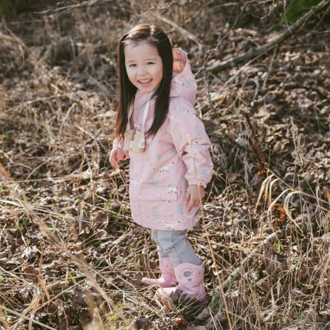 JAN & JUL Cozy Dry pink waterproof toddler rain jacket with hood and forest pattern.