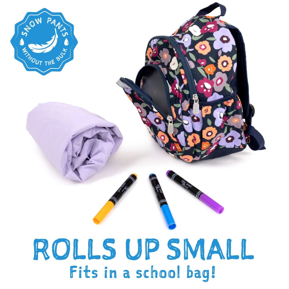Jan & Jul Waterproof Cozy Dry Rain Pants Dusty Blue rolled up beside a floral backpack, showing compact storage.