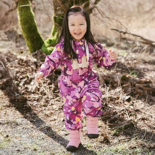 JAN & JUL Purple Dream waterproof rain suit for toddlers; child in a purple patterned suit with pink socks.
