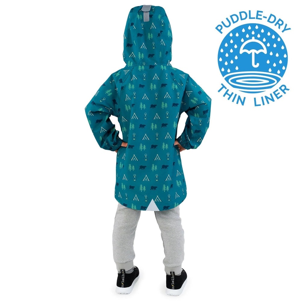 Jan & Jul Waterproof Puddle Dry Rain Jacket Summer Camp worn by a child with hands on hips, teal hooded with camp icons.