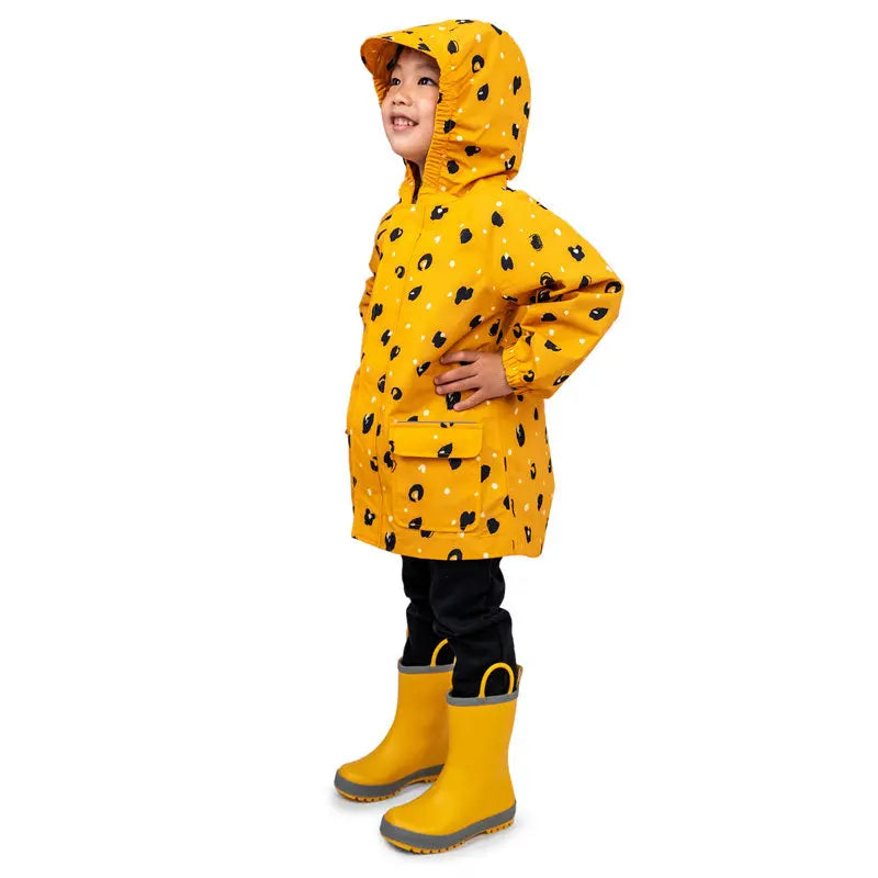 JAN & JUL Waterproof Puddle Dry Rain Jacket Wild Child in yellow with black spots; child poses with hands on hips wearing matching boots