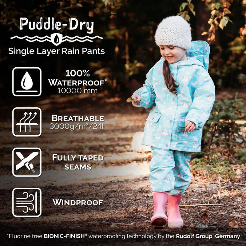 JAN & JUL Waterproof Puddle-Dry Rain Pants in dusty pink; child walks outdoors in rain-ready pants with fully taped seams.