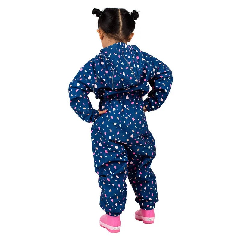 Jan & Jul Waterproof Puddle Dry Rain Suit Terrazzo, toddler in blue terrazzo with pink accents standing with hands on hips (back view).