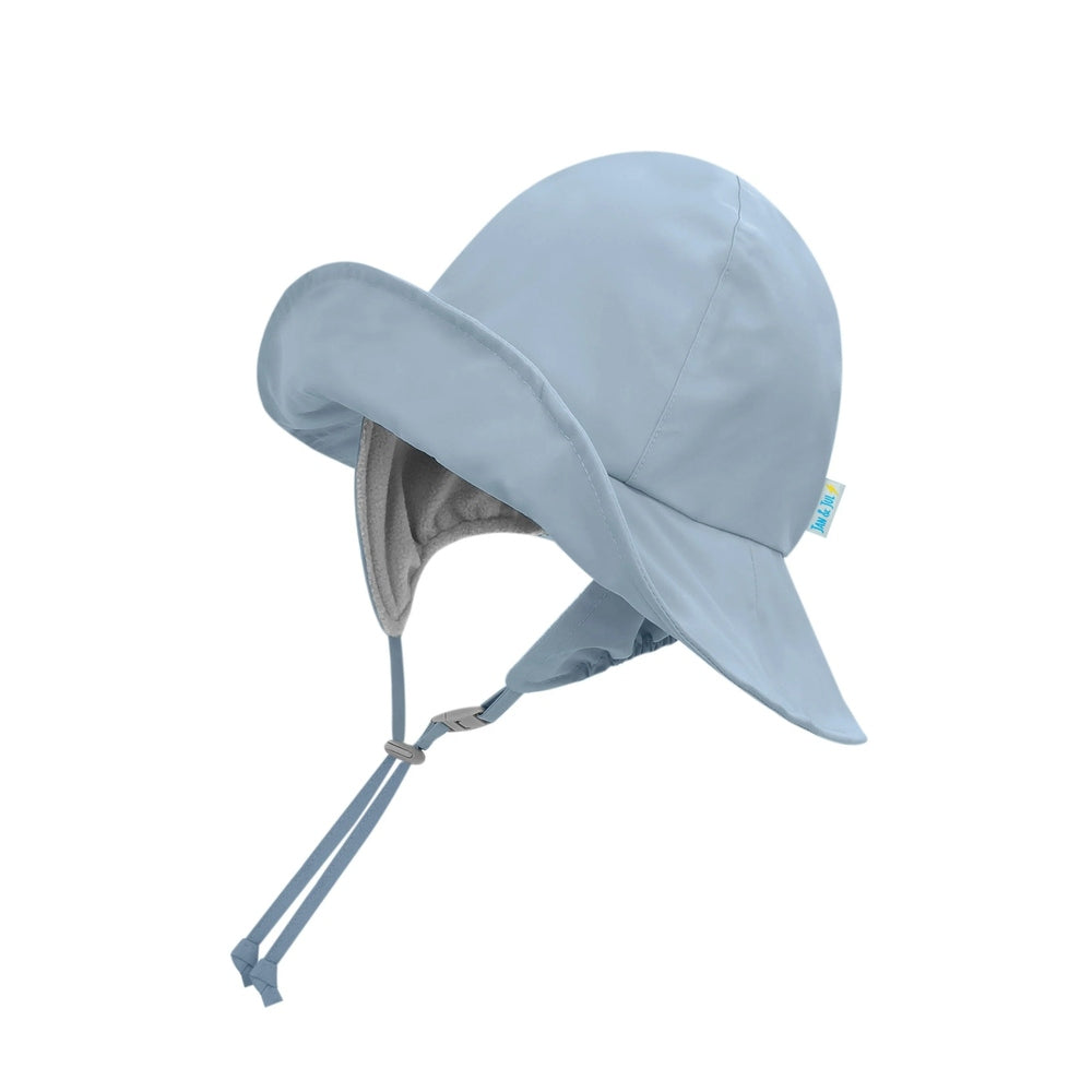JAN & JUL waterproof rain hat in dusty blue with a wide brim, ear flaps and adjustable chin straps