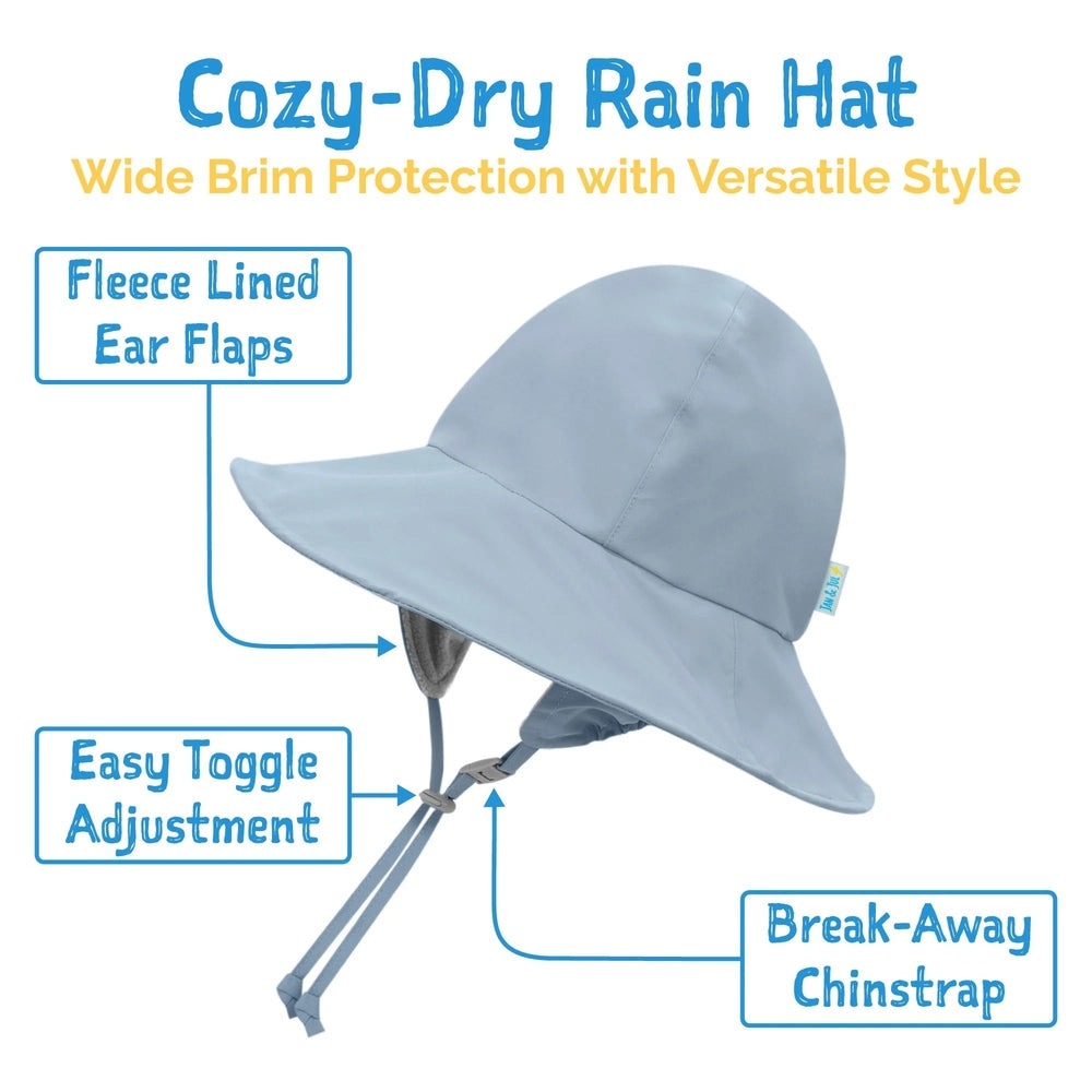Jan & Jul Dusty Blue waterproof rain hat with fleece-lined ear flaps, wide brim, and break-away chinstrap