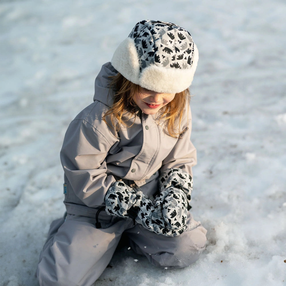 Jan & Jul Waterproof Toasty Dry Mitten Bear Cub mittens on a toddler kneeling in snow, grey waterproof fabric with plush lining