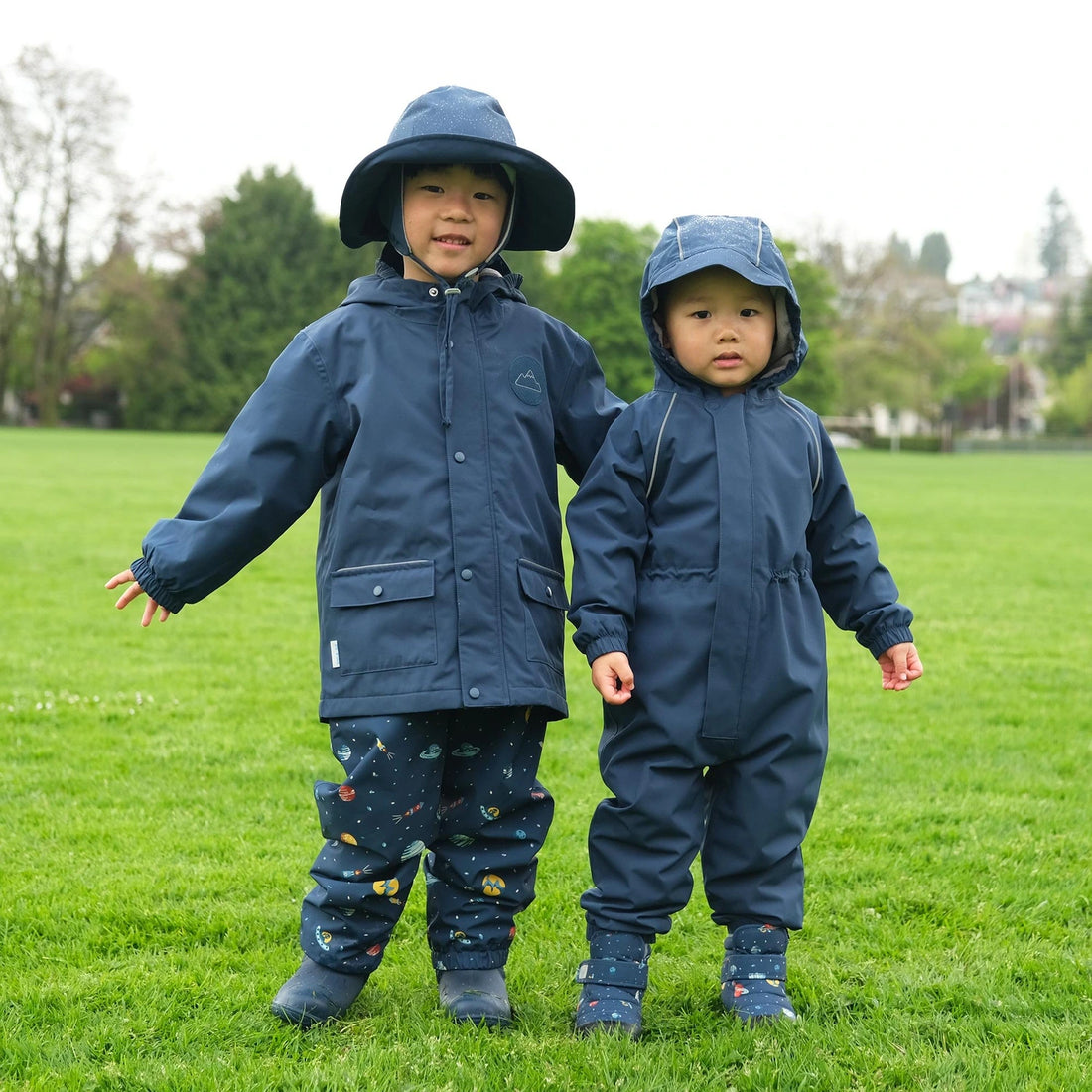 Jan & Jul Cozy-Dry Fleece Lined Rain Pants Planet Patrol — children wearing Planet Patrol rain pants outdoors