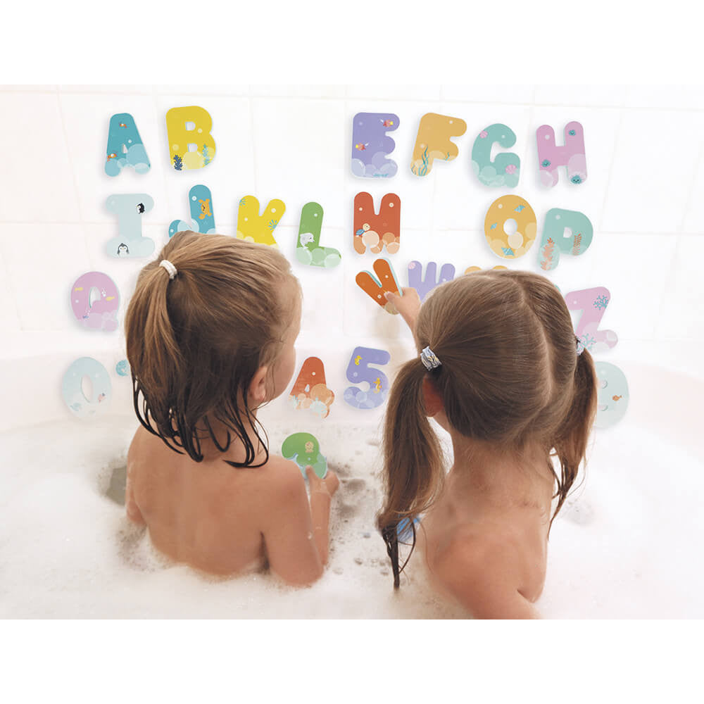 Bath time letters and numbers set by JANOD; colorful foam letters on wall as two kids bathe in bubbles