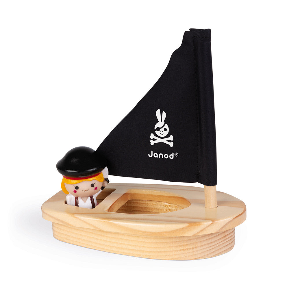 Janod Captain Melo boat bath toy with wooden hull, black sail, and captain figure
