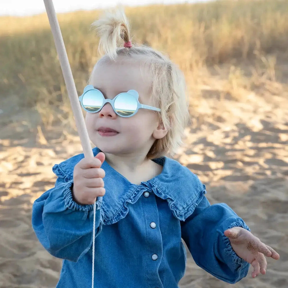 KI ET LA Ki Et La Ourson Sunglasses Sky Blue round baby sunglasses with mirrored lenses and soft frame shown laid flat in almond gr img 2/4