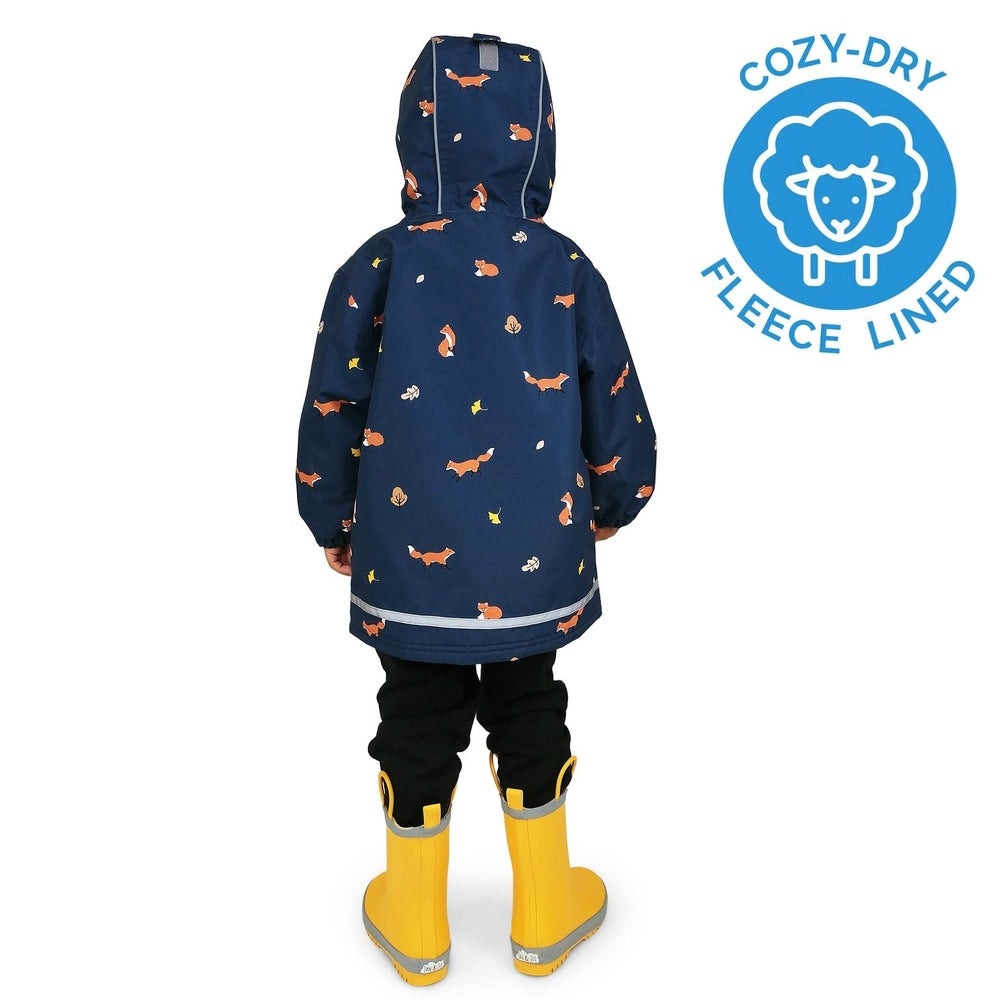 JAN & JUL Waterproof Cozy Dry Rain Jacket Navy Fox, fleece-lined with fox prints, worn by a child in yellow rain boots.