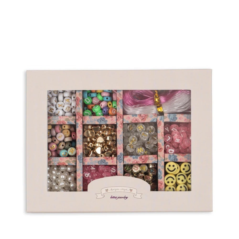 Konges Slojd Abc Jewellery Set in a pink floral tray with colorful alphabet beads and charms.