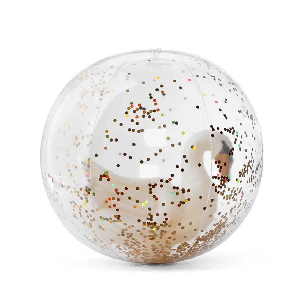 Konges Slojd Beach Ball: clear sphere with scattered gold confetti dots resting on a white surface.