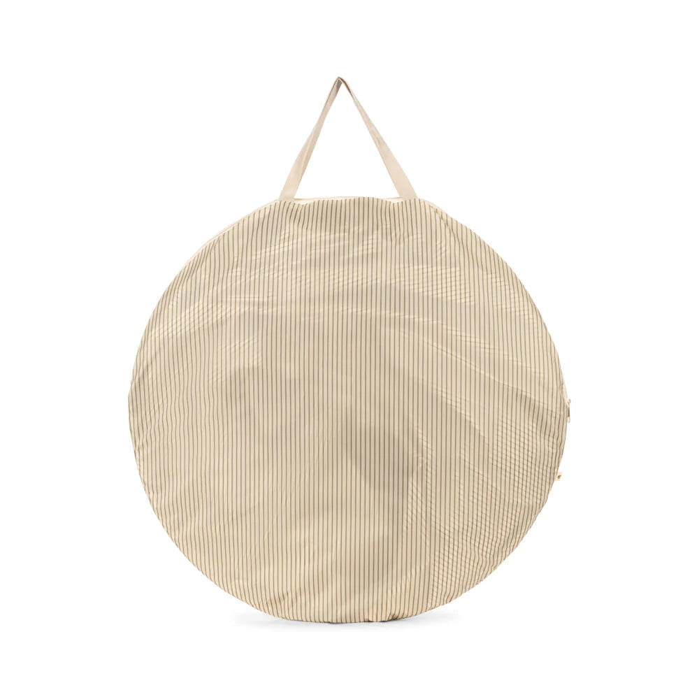 Round beige bag with a strap on a white background