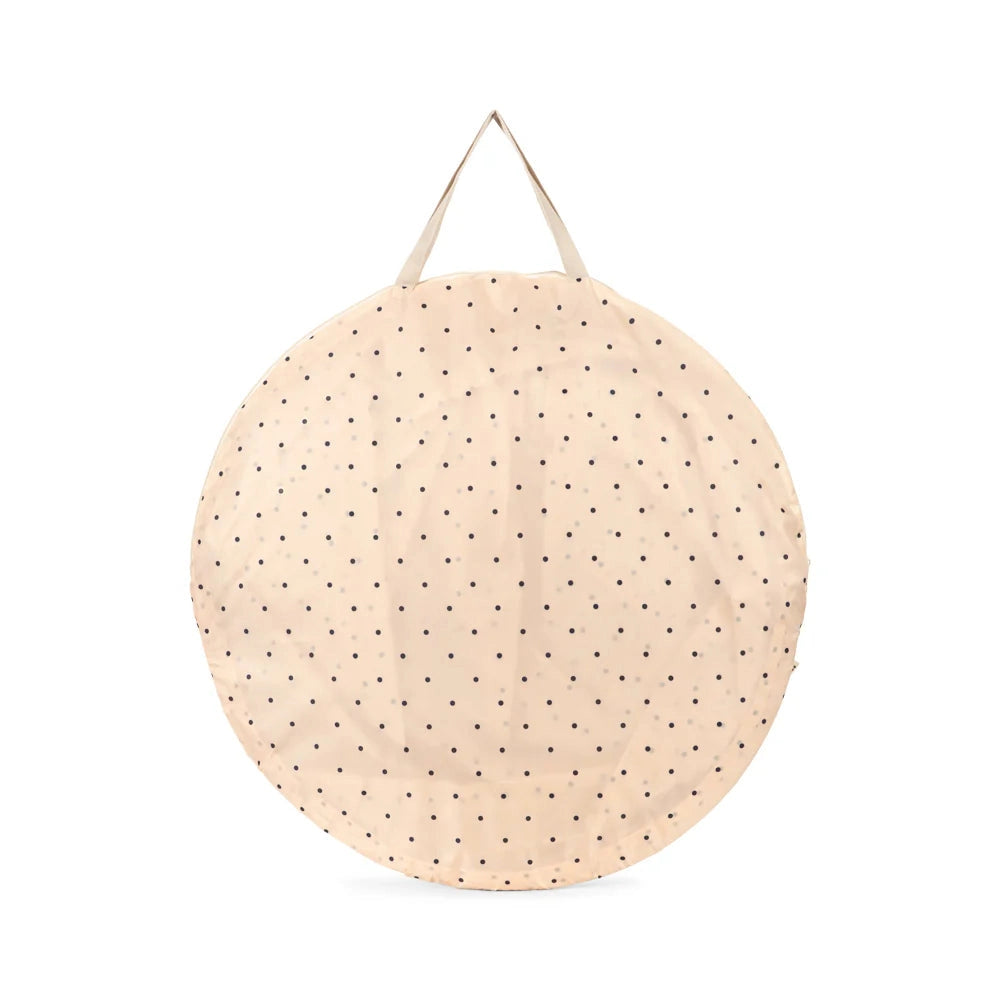 Round beige mat with black polka dots on a white background