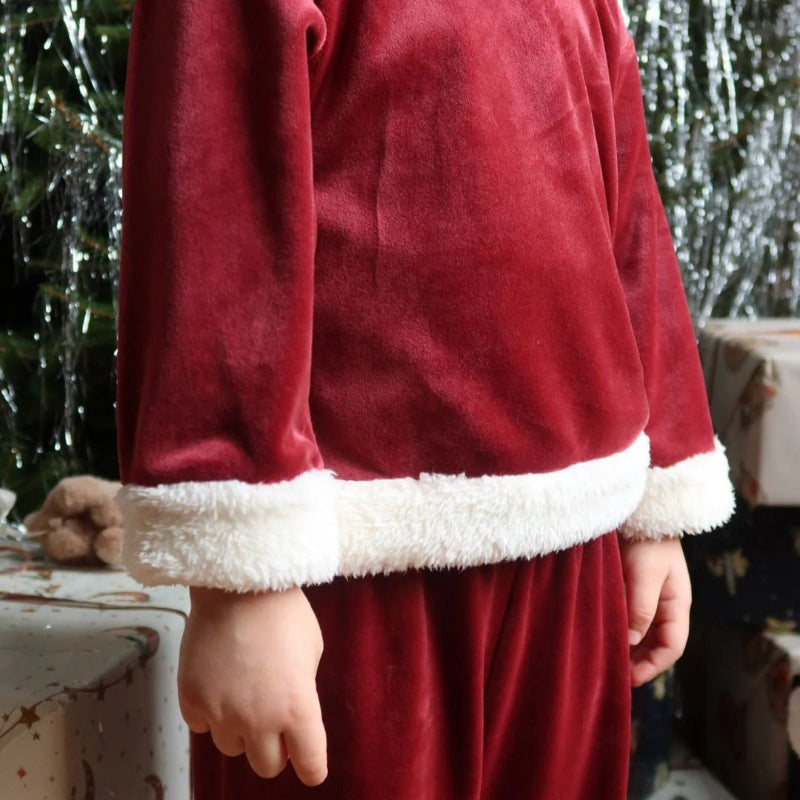 Konges Slojd Christmas Set Red Dahlia worn by a child in red velvet with white faux-fur cuffs and hem.