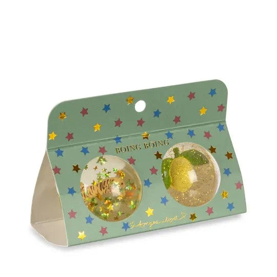 Konges Slojd Glitter Bouncing Ball Set Lemon/Tiger in mint packaging with star confetti, showing two clear glitter balls you can bounce.