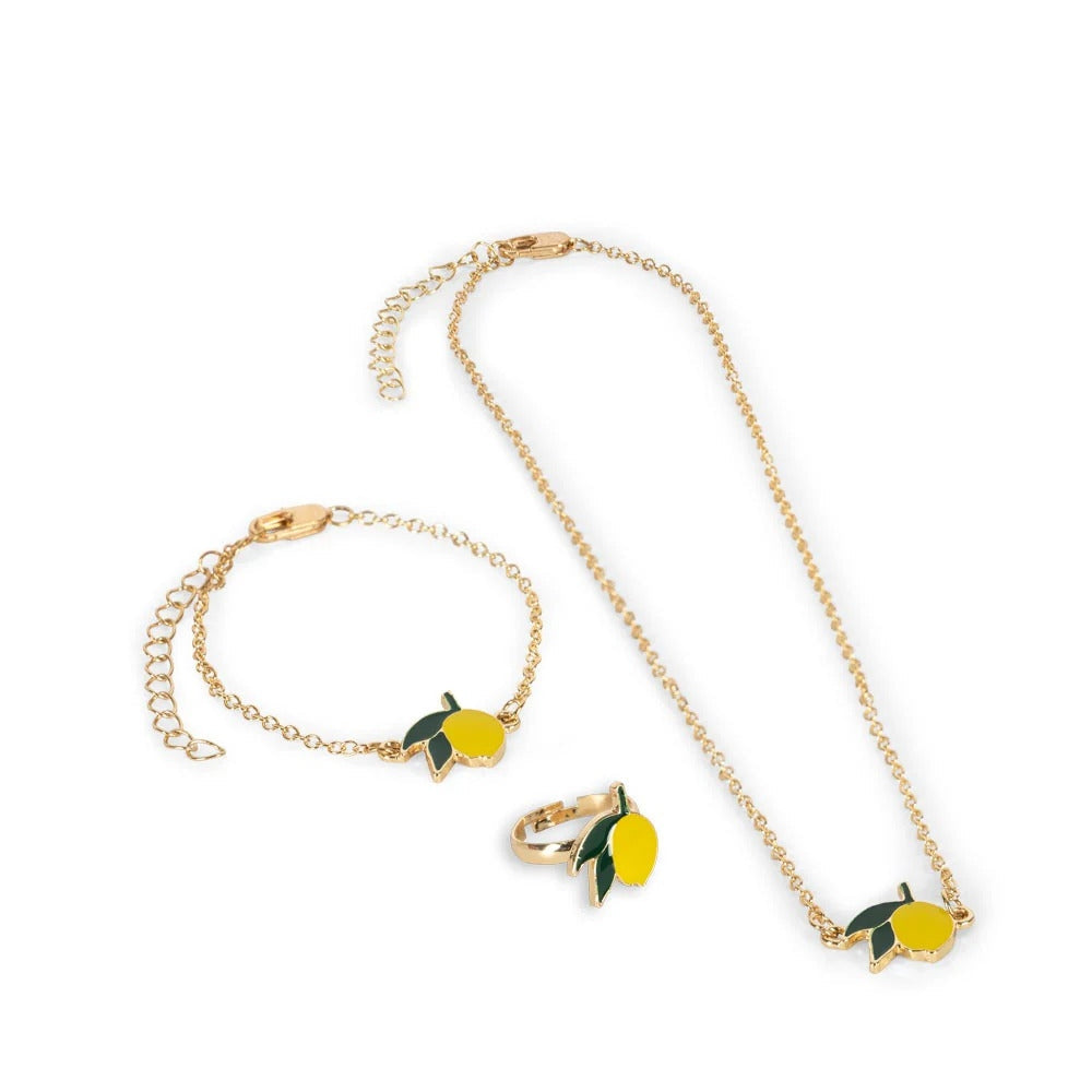 Konges Slojd Jewelry Set: gold-tone lemon pendant necklace, bracelet, and ring with green leaves laid out on white background