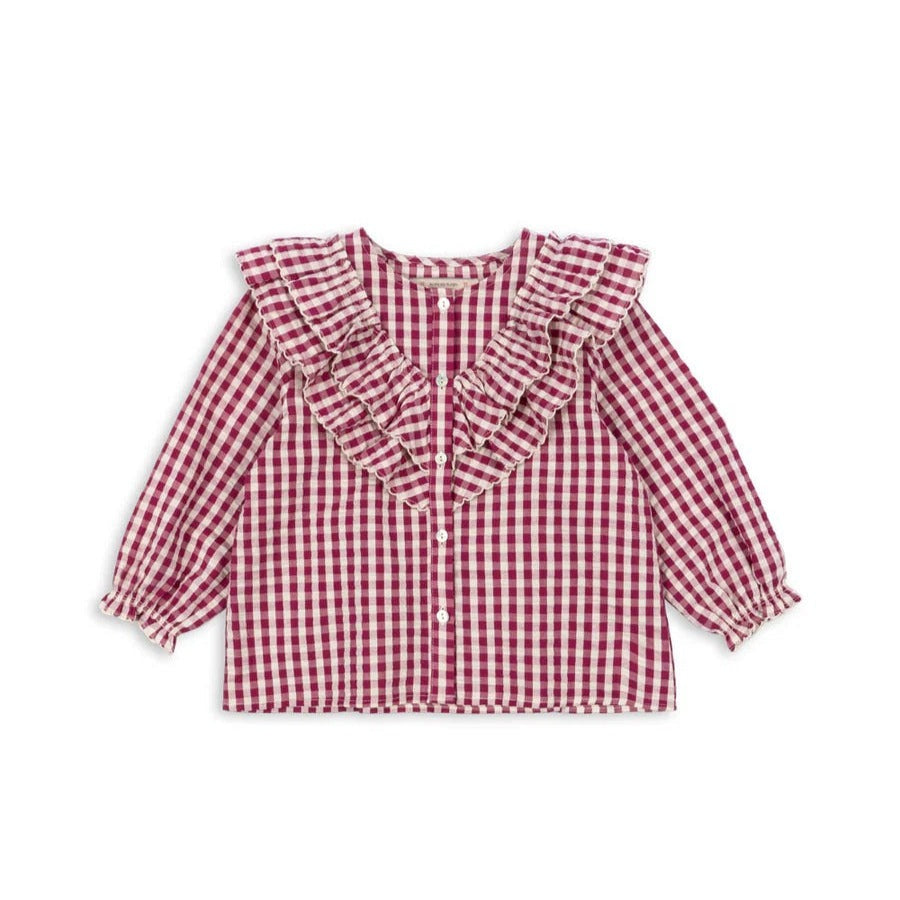 Konges Slojd Kim Frill Blouse Sangria Butter Check, pink gingham baby top with frill collar and elastic cuffs laid flat.